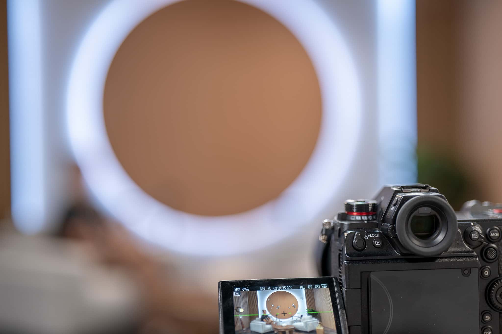Orbit Set – Iconic Podcast Studio with Glowing Circular Backdrop & Wood Paneling - Podcast Space in Dubai