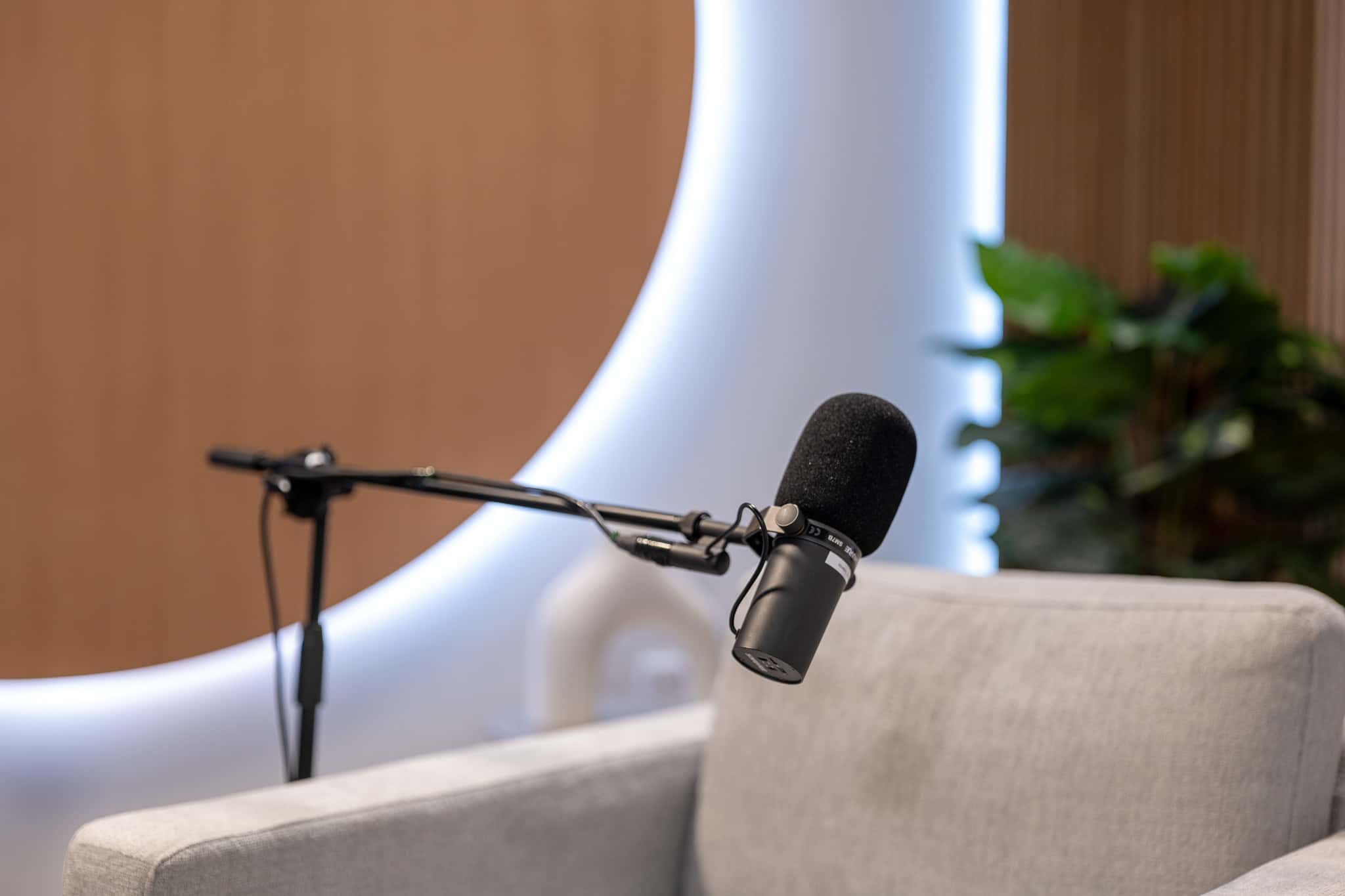 Orbit Set – Iconic Podcast Studio with Glowing Circular Backdrop & Wood Paneling - Podcast Space in Dubai