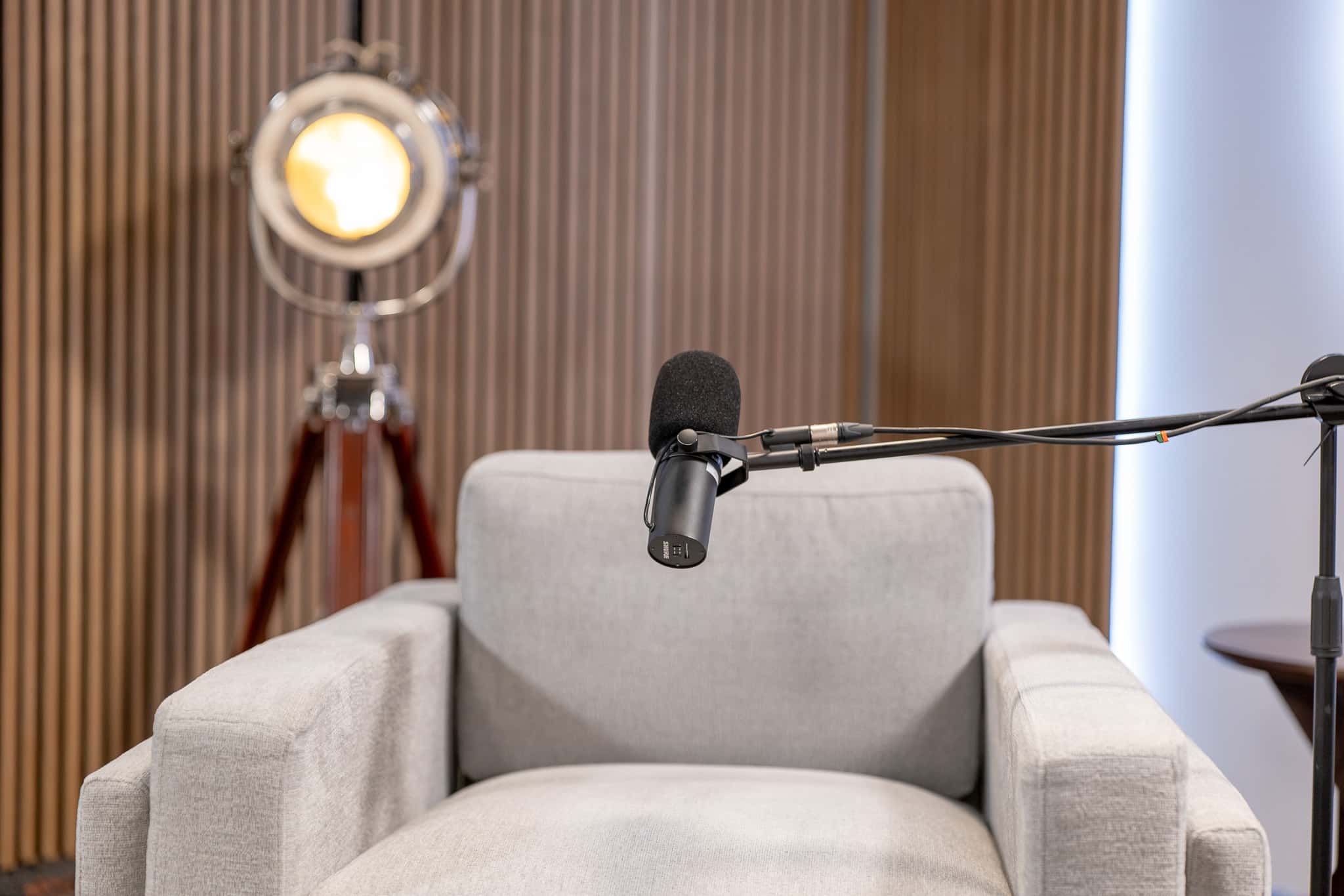 Orbit Set – Iconic Podcast Studio with Glowing Circular Backdrop & Wood Paneling - Podcast Space in Dubai