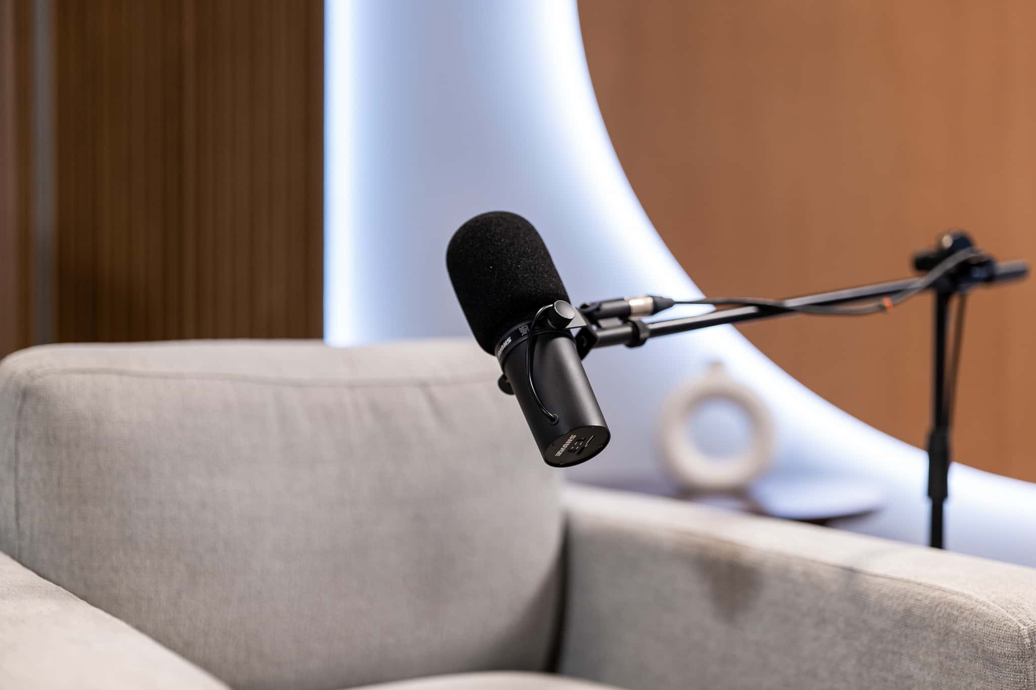 Orbit Set – Iconic Podcast Studio with Glowing Circular Backdrop & Wood Paneling - Podcast Space in Dubai